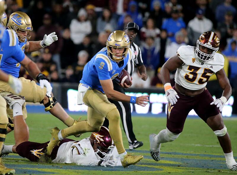 UCLA quarterback Colin Schlee scrambles out of the pocket in the second half.