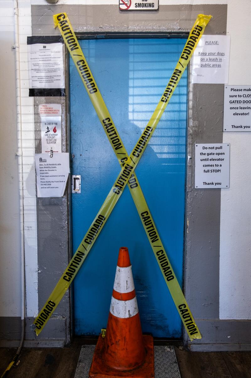 Caution tape covers the elevator inside the Madison Hotel - a single-room occupancy (SRO) 