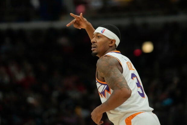 Phoenix Suns guard Bradley Beal holds up three fingers after sinking a three-point shot during the first half of an NBA basketball game against the Chicago Bulls, Wednesday, Nov. 8, 2023, in Chicago