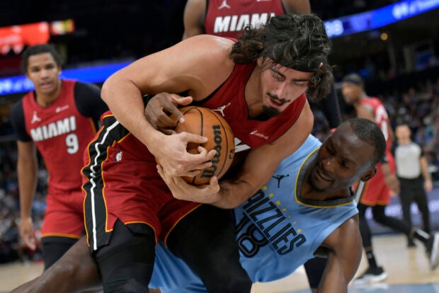 Miami Heat guard Jaime Jaquez Jr., left, handles the ball against Memphis Grizzlies center Bismack Biyombo in the first half of an NBA basketball game, Wednesday, Nov. 8, 2023, in Memphis, Tenn.