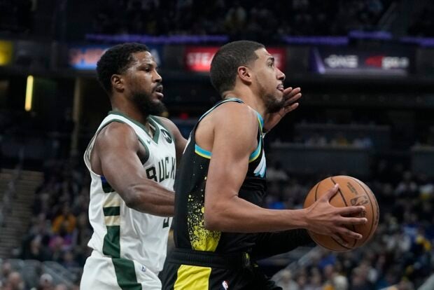 Indiana Pacers' Tyrese Haliburton, right, goes to the basket against Milwaukee Bucks' Malik Beasley during the first half of an NBA basketball game, Thursday, Nov. 9, 2023, in Indianapolis.