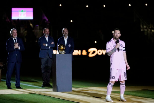 Inter Miami forward Lionel Messi, right, speaks during a ceremony honoring his Ballon d'Or trophy, before the team's club friendly soccer match against New York City FC, Friday, Nov. 10, 2023, in Fort Lauderdale, Florida.